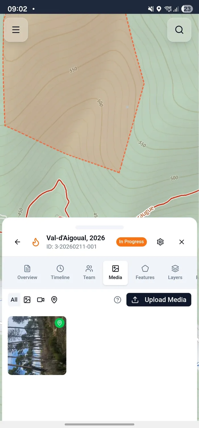 The incident map showing the fire perimeter with the media panel open at the bottom displaying an uploaded photo